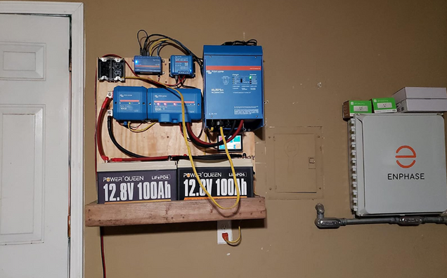 Electrical panel with 12V Lithium LiFePO4 Batteries on a wall, featuring Enphase equipment.