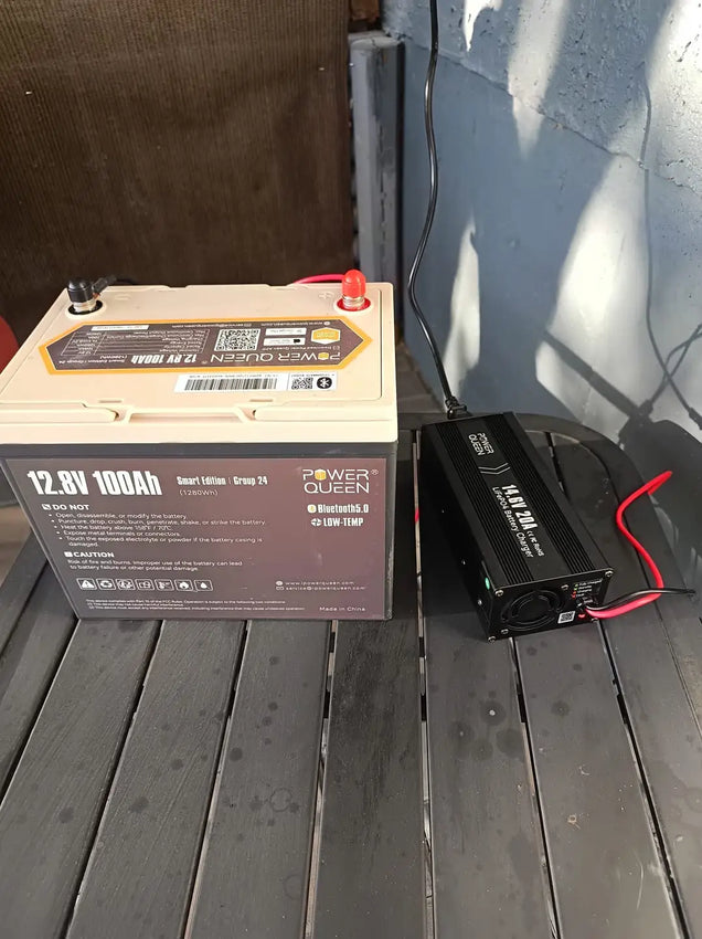 Power Queen battery andLifePO4 battery charger on a wooden surface