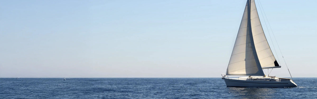 Sailboat cruising across open sea under sunlight with marine house power system - Power Queen US