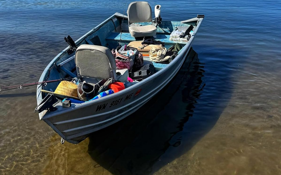 Fishing boat on a calm body of water with fishing gear and deep cycle lithium batteries inside