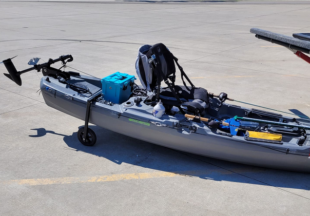 Small lithium ion battery on kayak with equipment on concrete surface