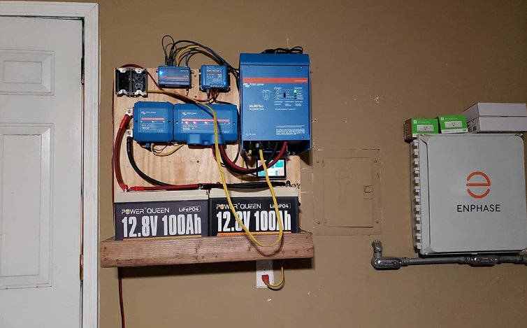 Electrical panel with lifepo4 deep cycle battery on a wall, featuring Enphase equipment.
