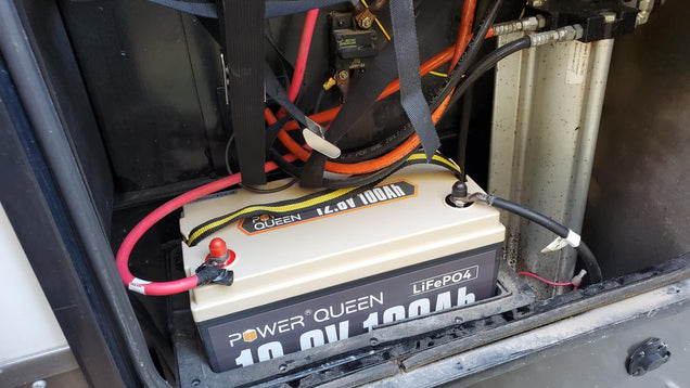 Power Queen 12V Lithium LiFePO4 Batteries with wiring inside a vehicle or machinery.