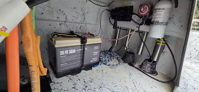 Power Queen 38.4V 50Ah LiFePO4 battery installed in a boat center console for advanced energy storage.